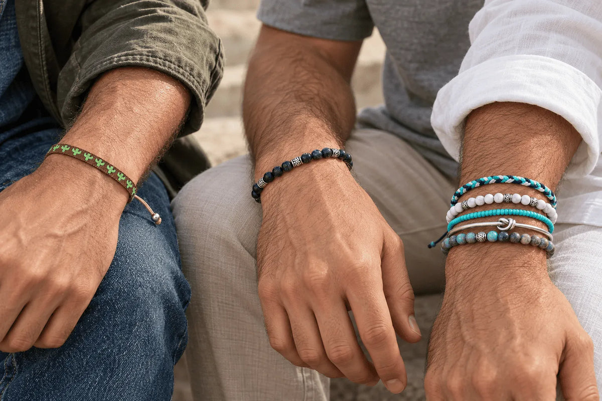 Three men wearing different bracelet styles, including woven, beaded, silver, and turquoise designs, showing some of the best bracelets for men.