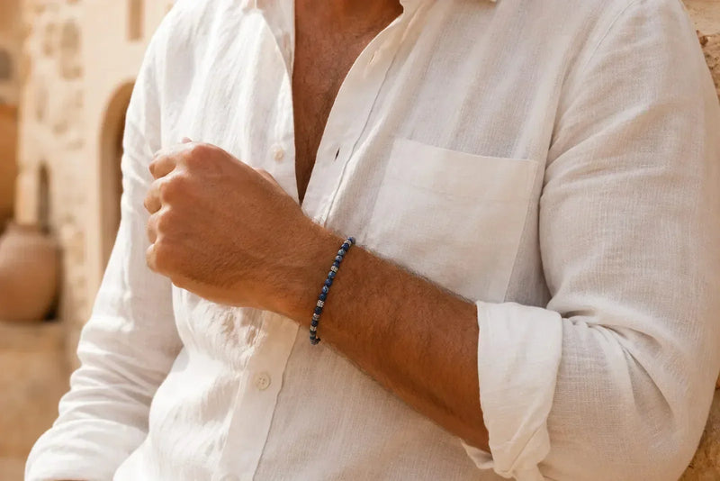 Man wearing a blue stone bracelet with silver details and a white linen shirt