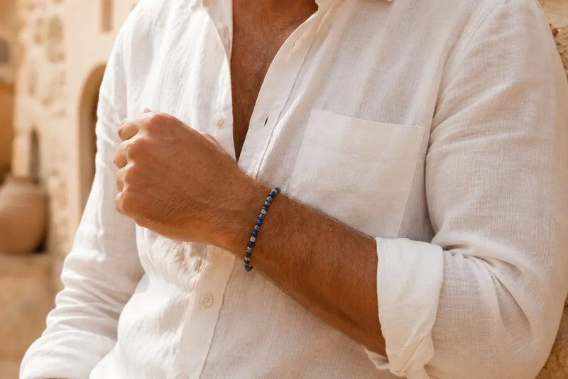 Man wearing a blue stone bracelet with silver details and a white linen shirt