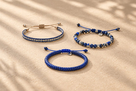 Three blue bracelets in woven, beaded, and clay styles illustrating different designs associated with blue bracelet meaning.