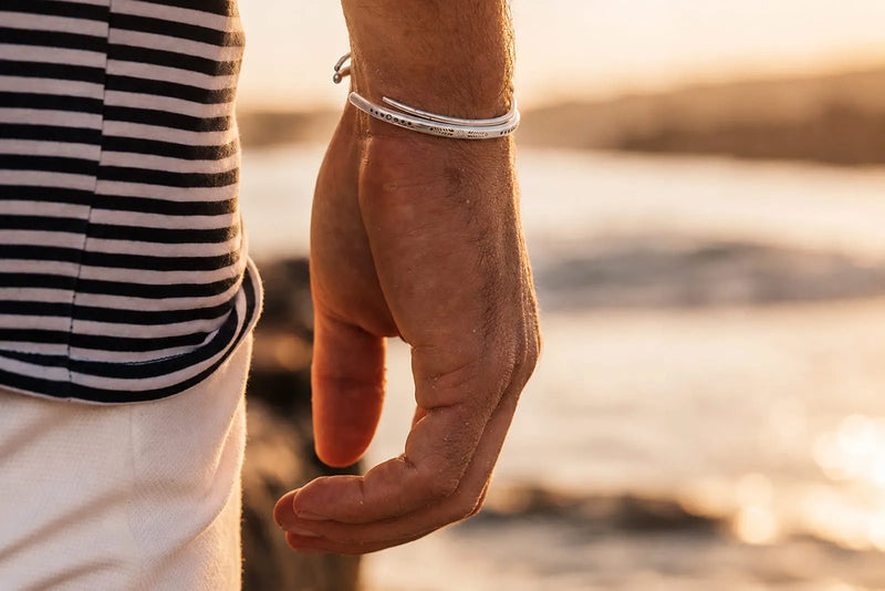 Can sterling silver tarnish? Man wearing a silver bracelet by the sea