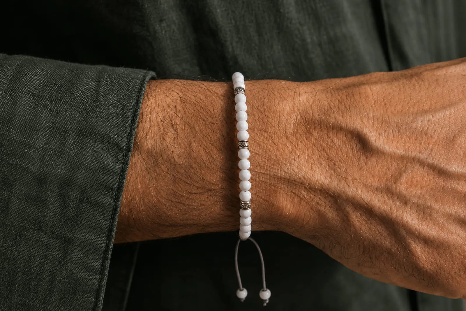 Jade Bracelet Beads for men featuring a slim white bracelet with silver spacers and an adjustable cord.
