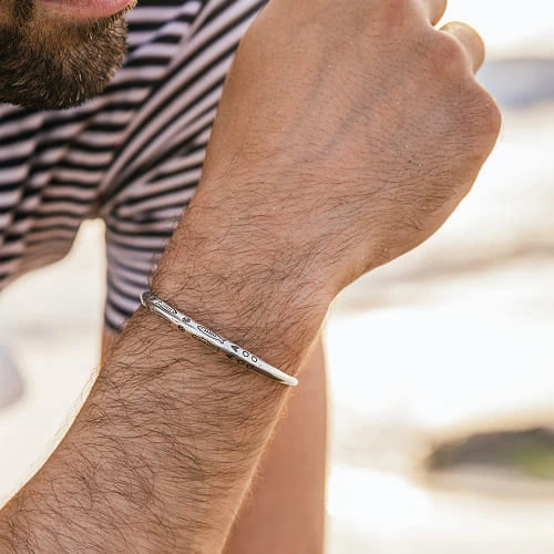 Men’s silver bracelet worn on wrist showing clean sterling silver design in everyday wear