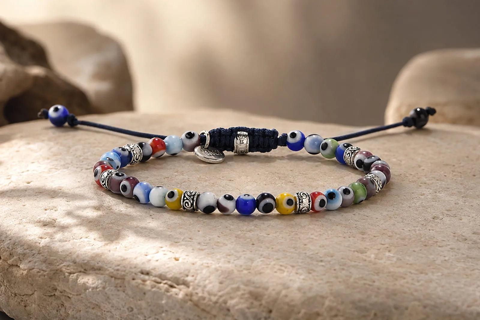 Rules for Wearing an Evil Eye Bracelet shown with a colorful beaded design arranged on a natural stone surface.