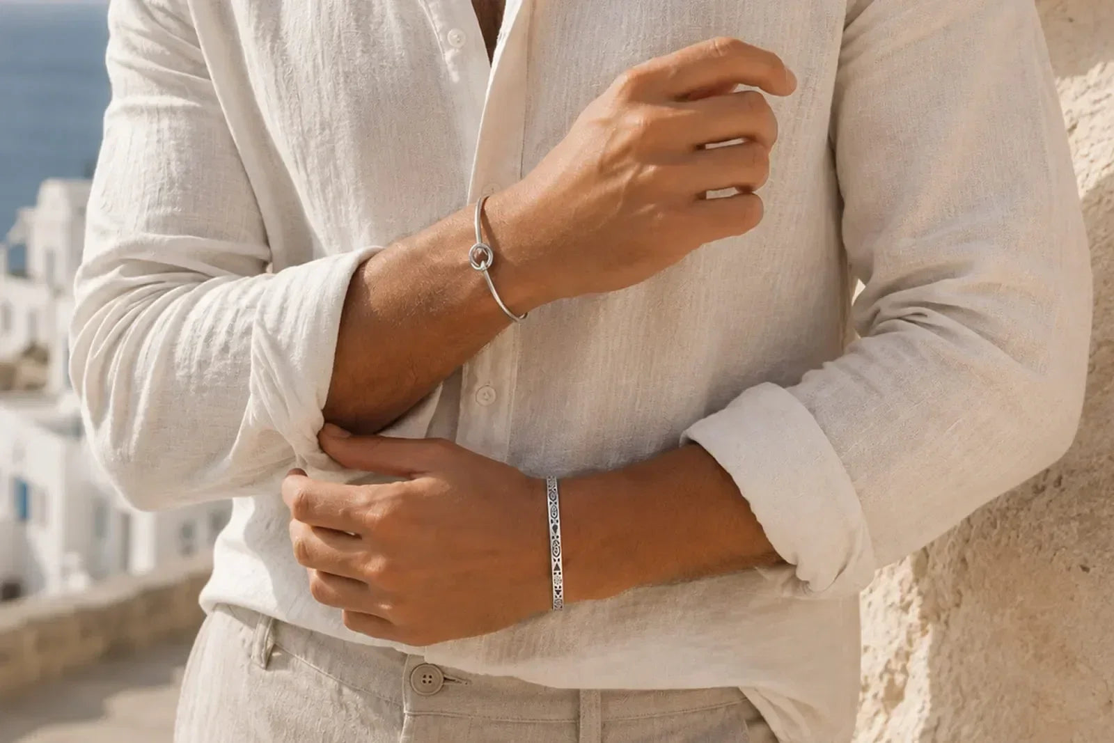 Which wrist should a man wear a bracelet on, shown with silver bracelets styled on both wrists