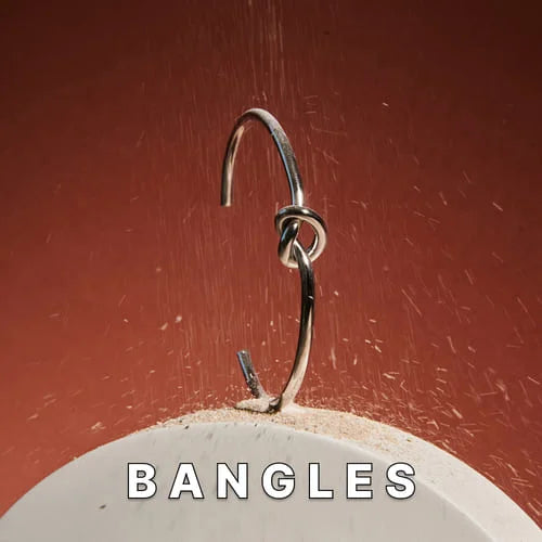 Close-up of Maresi metal bracelet bangle with knot detail