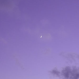 Lavender sky with crescent moon used as mood imagery for purple bracelet branding or product theme