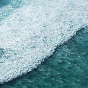 Aerial view of turquoise ocean waves, representing coastal energy in turquoise jewelry near me
