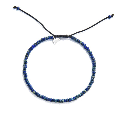 Flat lay of adjustable men’s beaded bracelet with glossy blue speckled seed beads