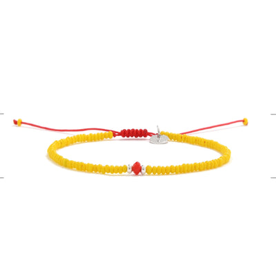 Adjustable bracelet with glass beads in yellow and red with silver charm