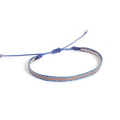 Adjustable blue braided bracelet with geometric woven design.