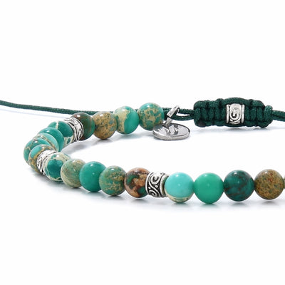 ide view of adjustable green jasper bracelet with round beads and silver spacers