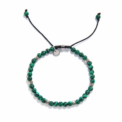 Malachite jewelry bracelet displayed flat with silver spacer accents