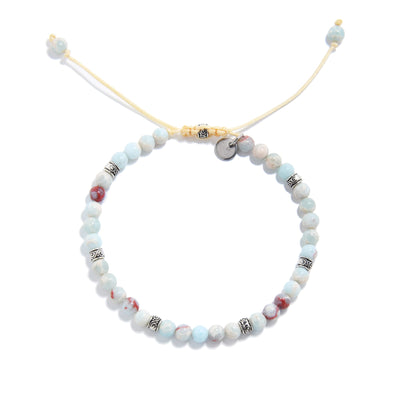 Top-down view of a circular Shoushan stone bracelet with evenly spaced silver spacers and an adjustable yellow cord, highlighting the soft pastel color palette.