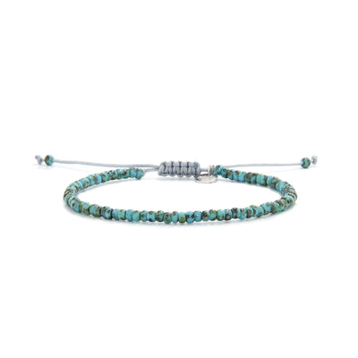 Handmade turquoise bead bracelet with silver charm and gray cord