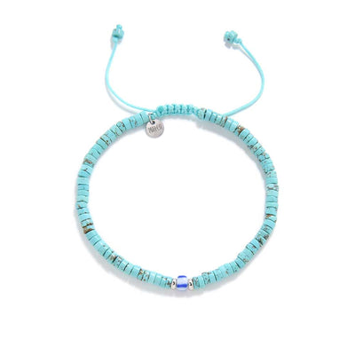 Adjustable turquoise men’s bracelets with round stone beads and silver charm on braided cord.