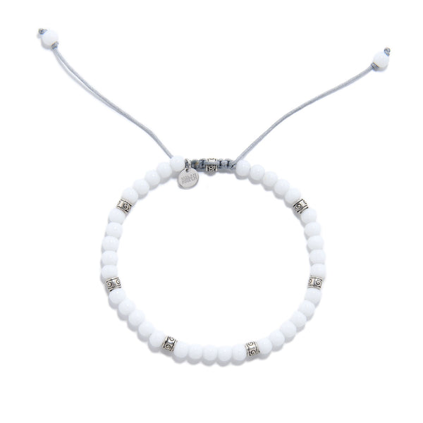 Adjustable white jade stone bead bracelet with silver decorative spacers.