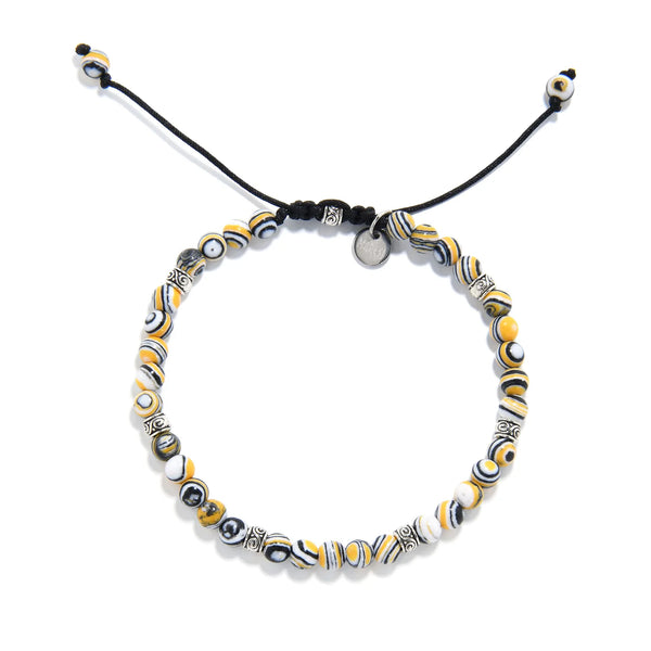 Adjustable black yellow bracelet featuring round man made malachite beads and silver spacers