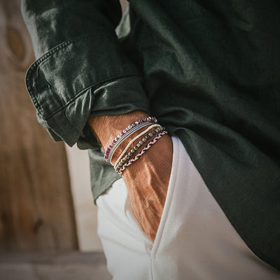 Man wearing Amalfi bracelet set with purple and silver tones