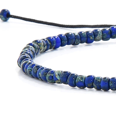 Close-up of beaded bracelet for men with mixed blue seed beads and black cord