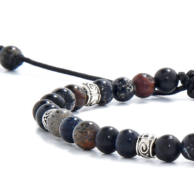 Black jasper beads close-up showing natural stone texture and silver spacer accents.