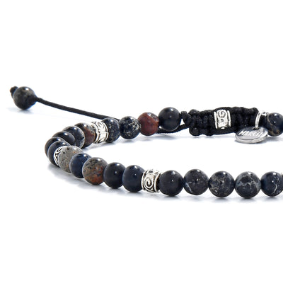 Black jasper beads close-up showing natural patterns and silver detailing.