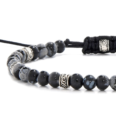 Close-up of black stone bracelet with silver accent beads and polished black jasper stones.