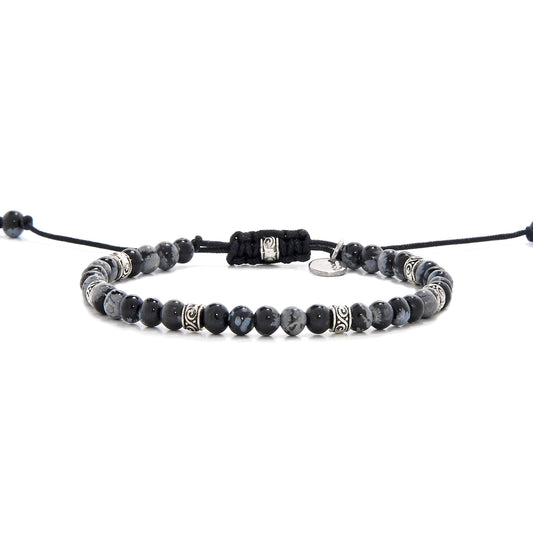 Full view of bracelet black stone featuring black jasper beads and silver decorative spacers.