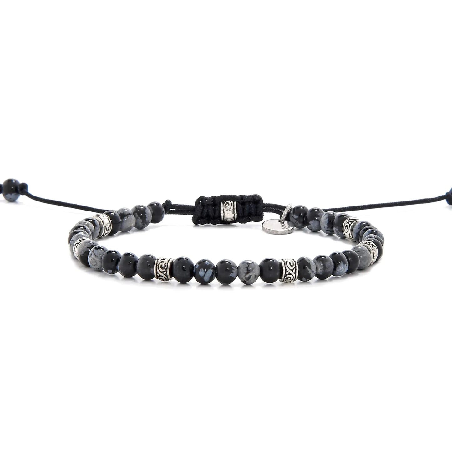 Full view of bracelet black stone featuring black jasper beads and silver decorative spacers.