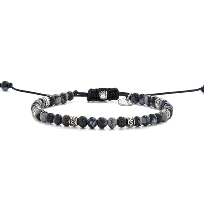 Full view of bracelet black stone featuring black jasper beads and silver decorative spacers.
