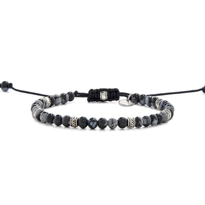 Full view of bracelet black stone featuring black jasper beads and silver decorative spacers.