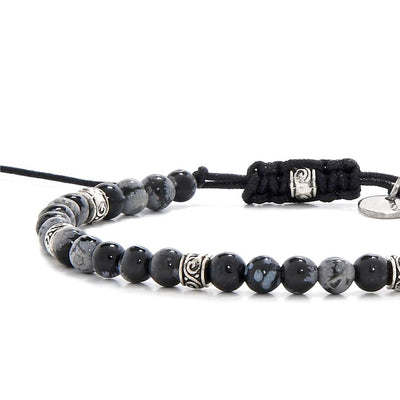 Black stone bracelet with polished black jasper beads and silver accents on a black cord.