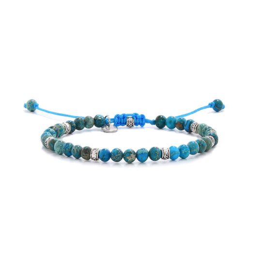 Full view of blue jasper jewelry bracelet featuring polished beads and silver detailing.