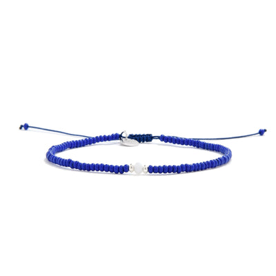 Blue seed bead bracelet idea with white bead centerpiece and navy adjustable cord