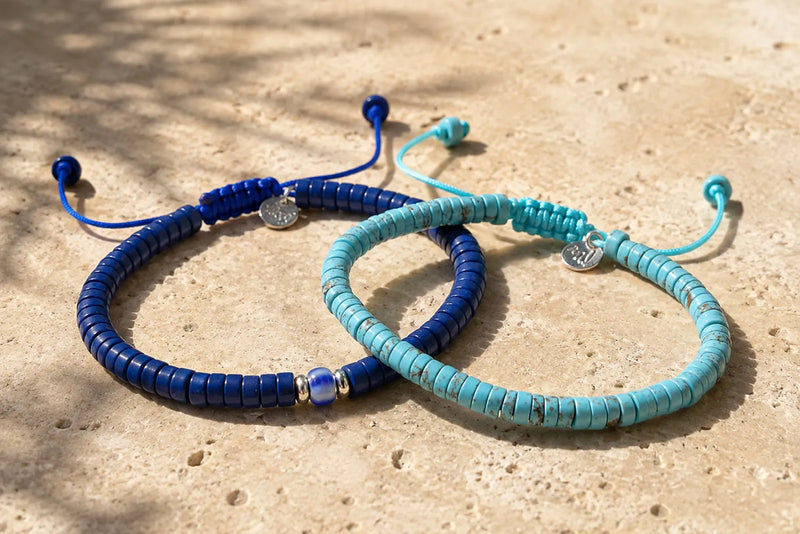 Blue and turquoise bracelet color combos featuring two slim men’s bracelets on warm limestone