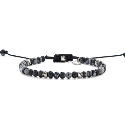 Full side view of the Bracelet Black Stone laid out flat with black cord and adjustable clasp.