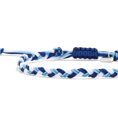 Detailed view of braided matching friendship bracelets in layered blue tones with sliding knot