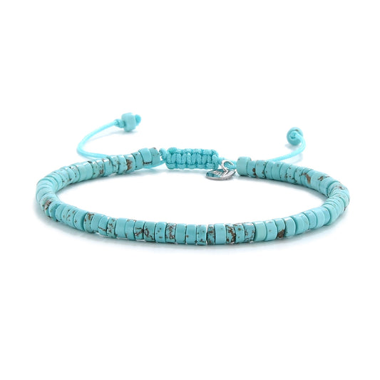 Front-facing image of turquoise beads bracelet with signature knot