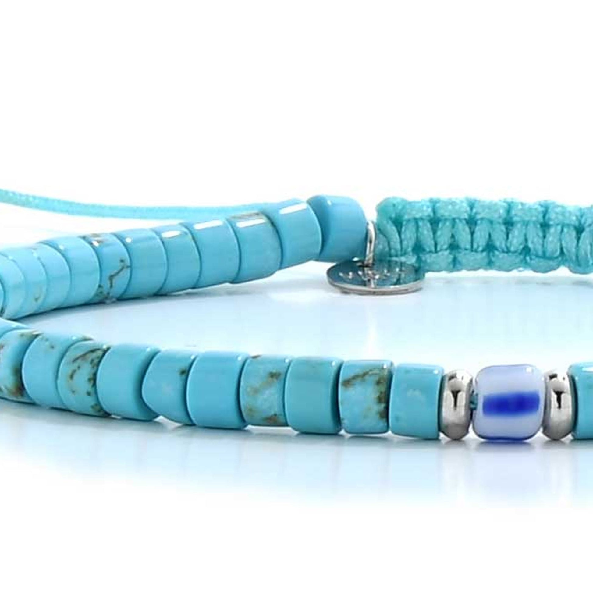 Close-up of turquoise clay beads for bracelets with blue accent bead.