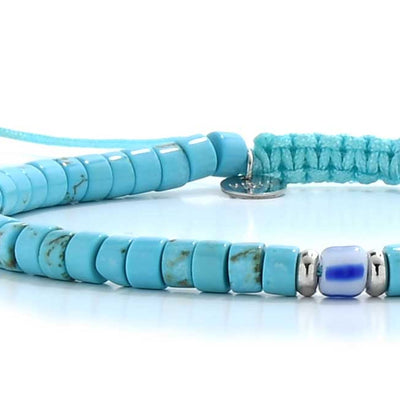 Close-up of turquoise clay beads for bracelets with blue accent bead.
