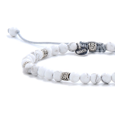 Detailed view of white crystal bracelet with silver spacer beads