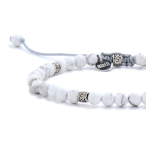 Detailed view of white crystal bracelet with silver spacer beads