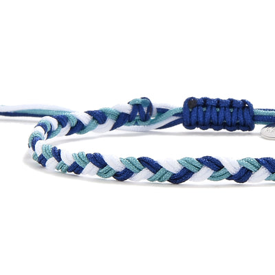 Close-up of handmade woven friendship bracelet in blue, teal, and white with braided pattern