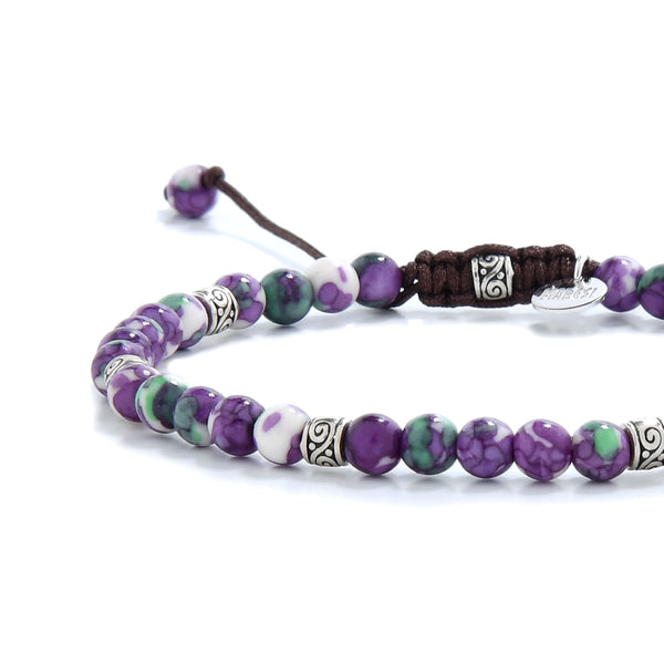 Purple jasper bracelet styled with ornate silver spacers and stone details.