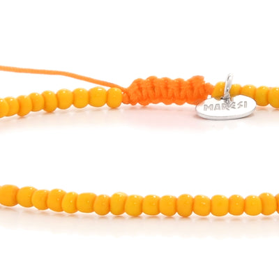 Detail view of orange men bead bracelet and logo charm

