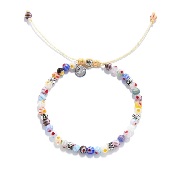millefiori bracelet with round handcrafted beads and adjustable yellow cord, laid flat.