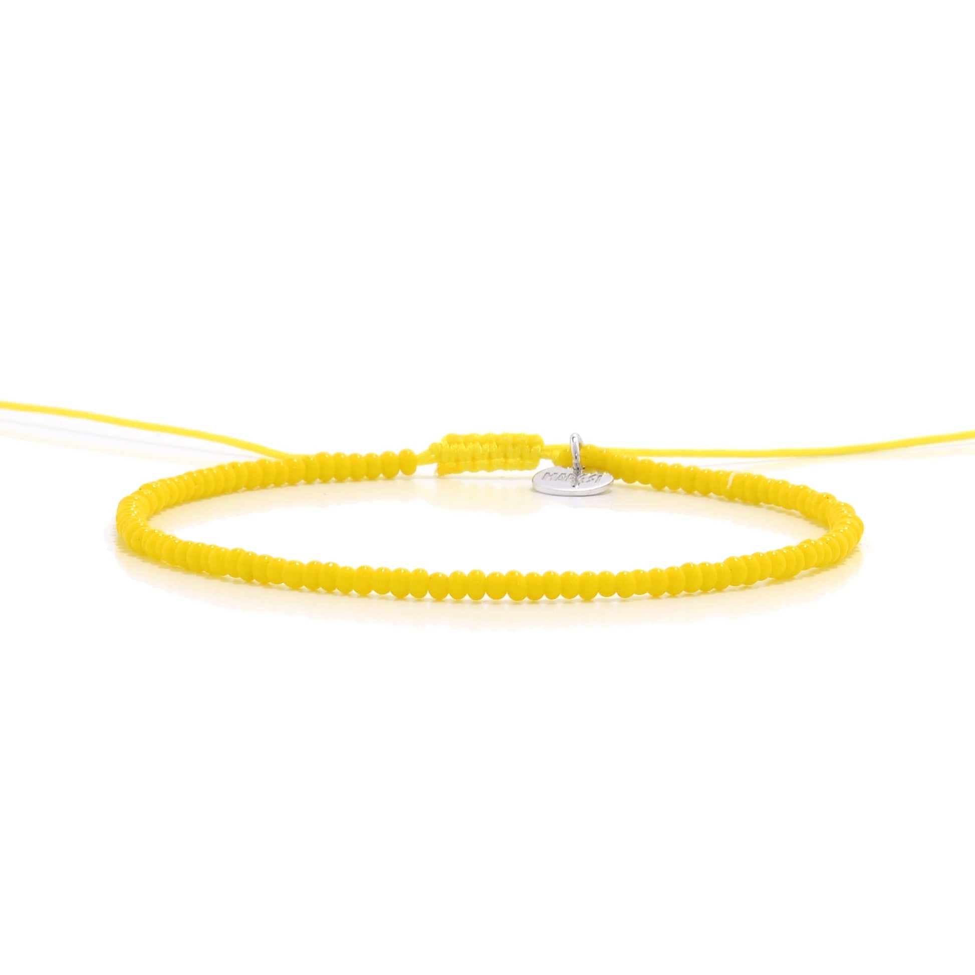 Straight-on image of bracelets beads in yellow with silver disc charm

