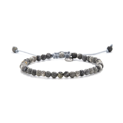 Beaded gray jasper bracelet with silver accent beads on adjustable cord.