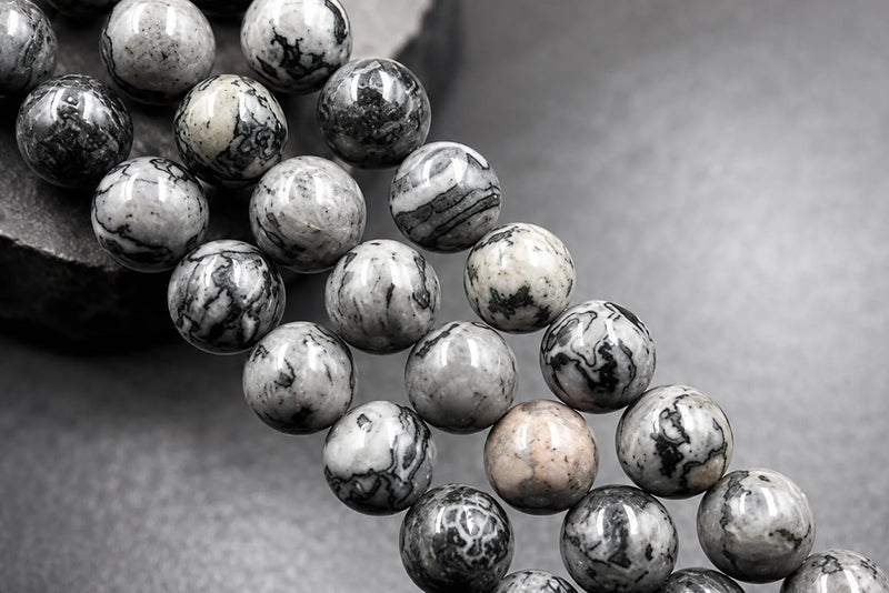 Gray Stone Jewelry beads in polished gray, white, and black marbled patterns for men’s bracelets.