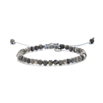 Beaded gray jasper bracelet with metal accent beads on adjustable cord.